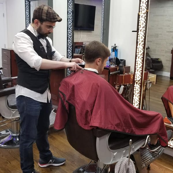 Picture of a barber trimming hairs